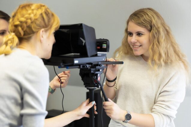 Woman looking at a teleprompter device