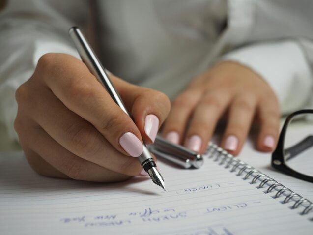 Woman writing on a notebook