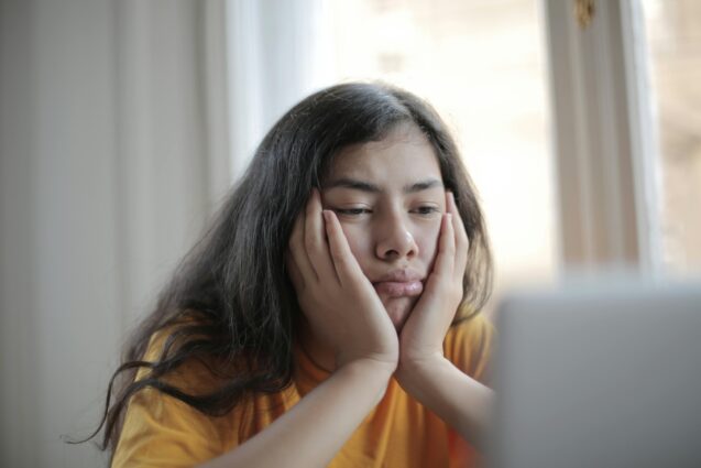 Woman with both of her hands on her face