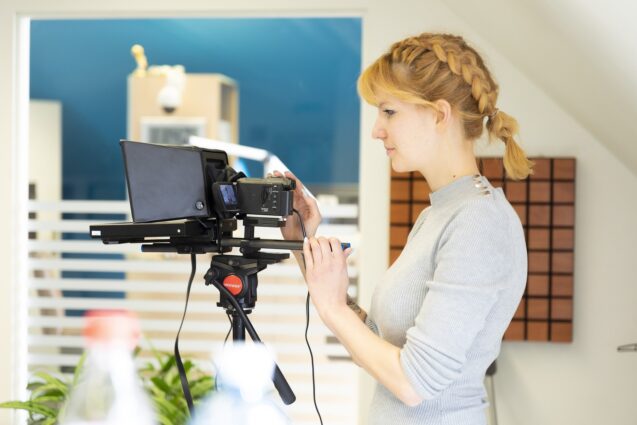 Woman adjusting the settings of the teleprompter