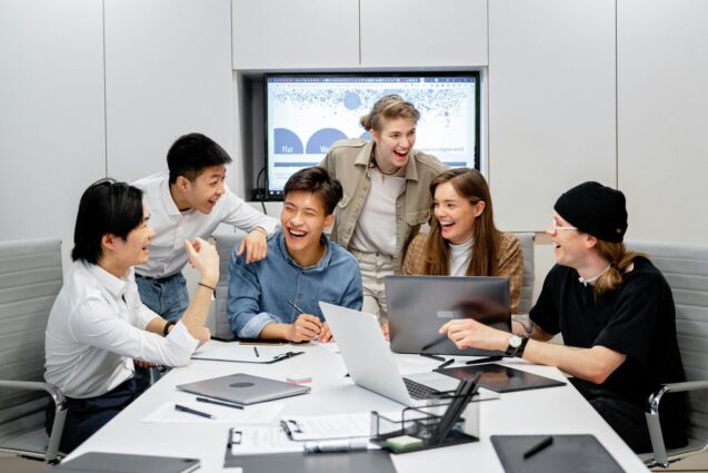 Group of employees laughing together during a meeting