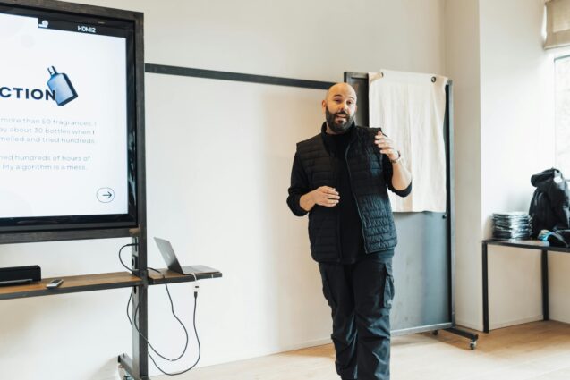 A bald man speaking in front