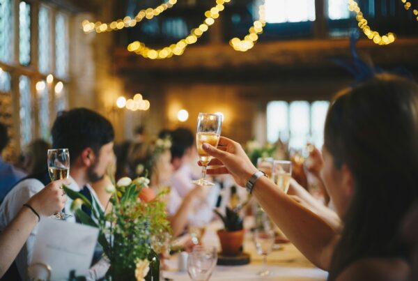 Guests raising their champagne glasses during a toast