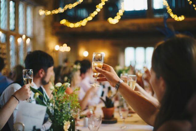 Guests raising their champagne glasses during a toast