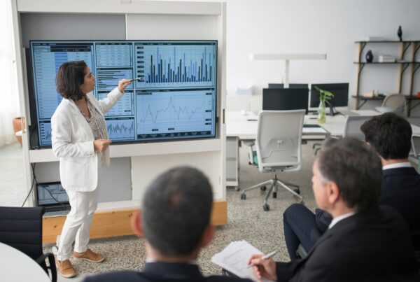 Woman pointing at an infographic projection during a presentation