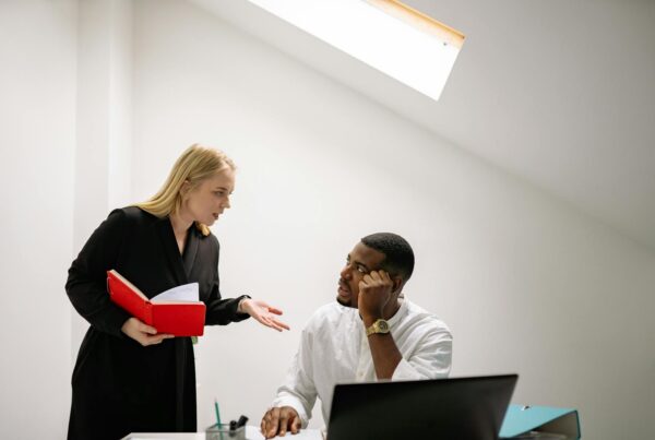 A man and woman engage in conversation within a professional office setting