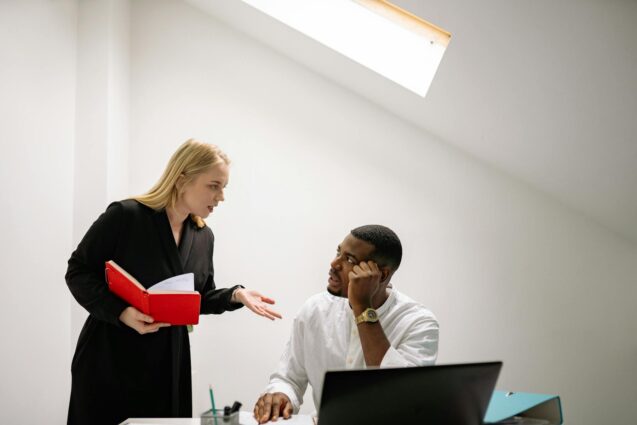 A man and woman engage in conversation within a professional office setting