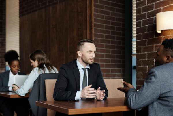 Businessman seated at a table engaged in conversation