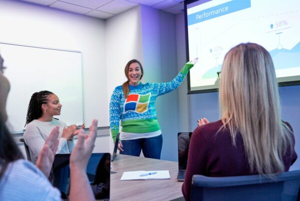 A woman presents to an audience, engaging them with her speech and visual aids