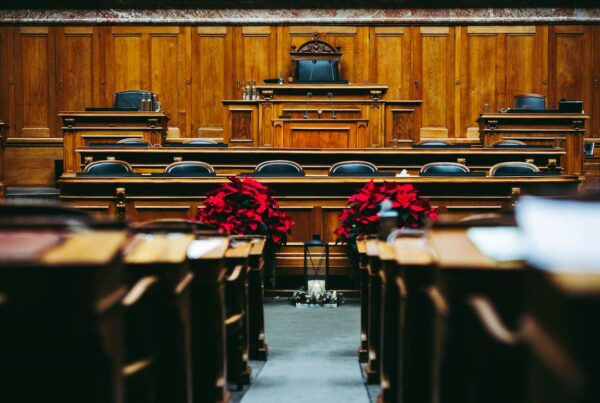 Empty wooden courtroom with red poinsettias at the front