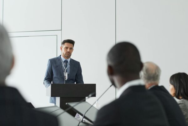 Businessman giving a speech at a conference podium