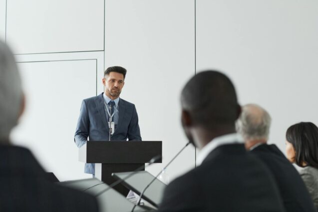 Businessman giving a speech at a conference podium