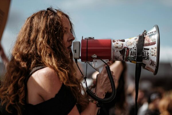 Woman speaking through a megaphone during a protest
