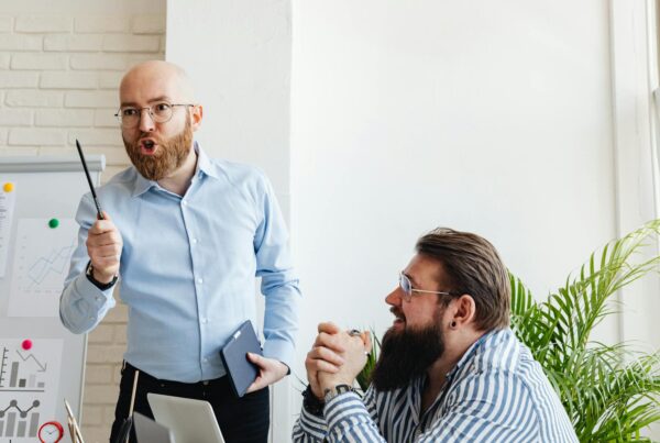 Man passionately presenting ideas to colleague during meeting