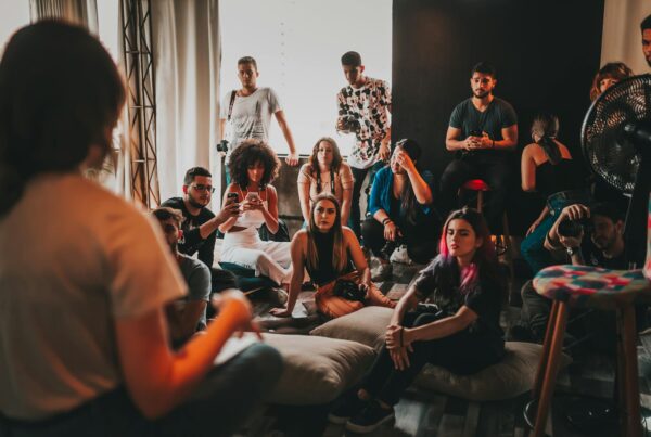 Group of people attentively listening during a casual indoor workshop