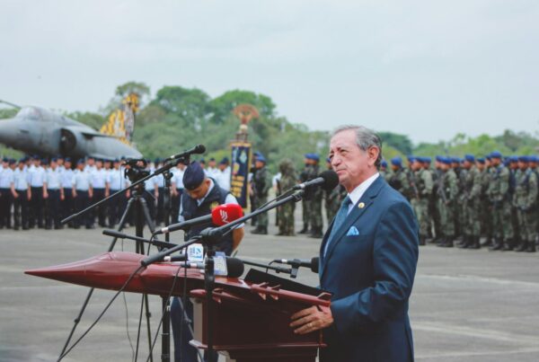 Man speaking at a podium during a military ceremony