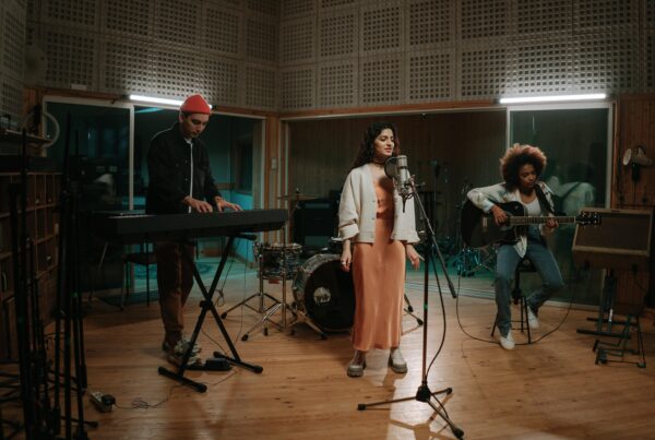 A band in a recording studio with the lead female artist singing