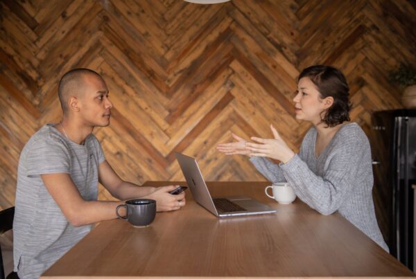 Two people having a conversation across a table